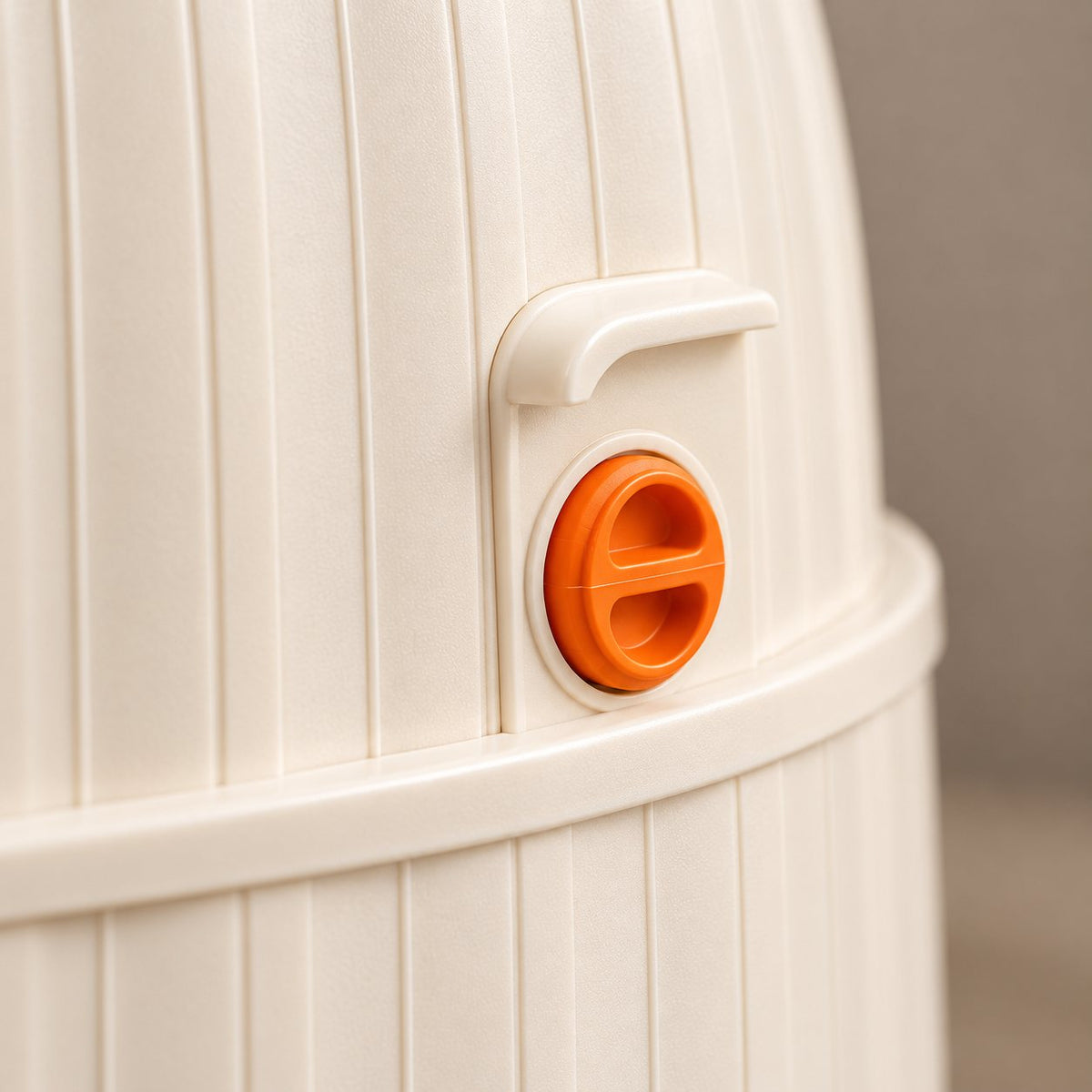 Close-up of the orange latch on the side of the planter top